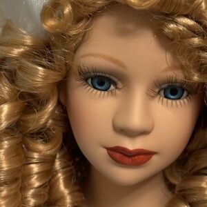 Blonde Curly-Haired Porcelain Doll with Blue Eyes
